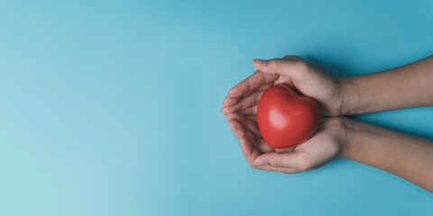 hands holding red heart, health care, love, organ donation, mindfulness, wellbeing, family insurance and CSR concept, world heart day, world health day, National Organ Donor Day, praying concept