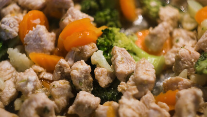 Chicken and vegetables stewed in pan. Concept. Close-up cooking hearty and healthy lunch with fresh...