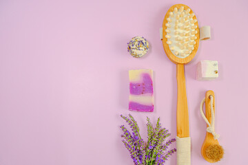 Lavender bath soap , truffles and natural bristle brushes and lavender flowers on a pink...