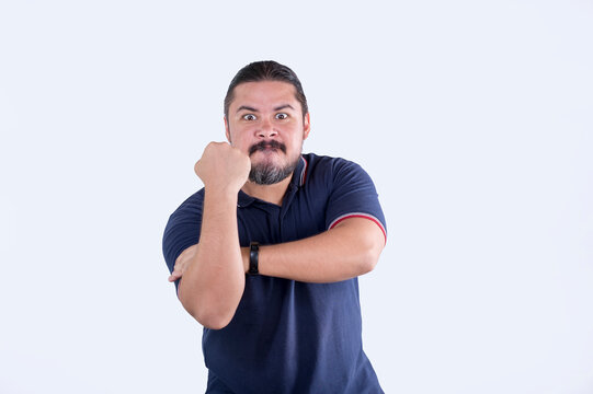 An upset man gives the Iberian slap. Showing contempt and anger, saying fuck you. Isolated on white backdrop.