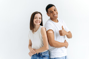 Healthcare concept. Happy hispanic guy and caucasian girl received a vaccine against various...