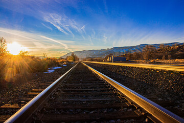 Railroad sunset in the rocky mountains with blue and orange skies