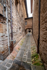 View of an old alley in the village of Spello (Umbria Region, Central Italy), a medieval village, famous for a flower country fair, named Infiorata (held yearly, between May and June).