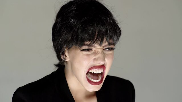 Shouting mouth, screaming face. Angry woman screaming with rage, furious and dangerous. Girl shouting with anger. Rage and aggressive concept.