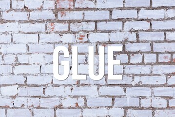 Fototapeta na wymiar GLUE - word on concrete background. Cement floor, wall.