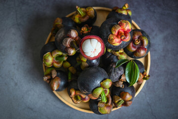 Mangosteen on plate and dark background, fresh ripe mangosteen peeled from tree at tropical fruit Thailand in summer
