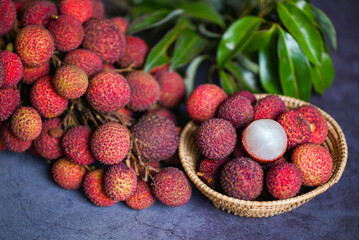 Lychee fruit with green leaf on black background, fresh ripe lychee peeled from lychee tree at tropical fruit Thailand in summer