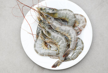 raw shrimp on white plate background for cooking, close up fresh shrimps or prawns, seafood shelfish