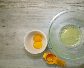 Two egg whites and yolks separated.