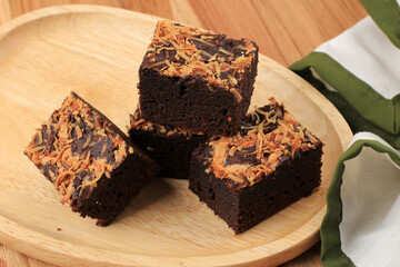 Bake Brownie with Shredded Cheese on Top Brownies Keju, Homemade Fresh Baked Chocolate Cake on Wooden Table.