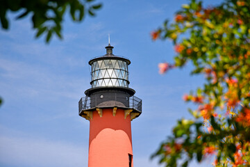 Historic red brick Jupiter lighthouse against blue skies at Jupiter Inlet, Florida © Ryan Tishken