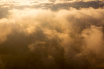 Golden sunset clouds close-up. View from above.