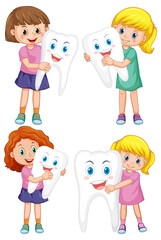 Set of happy kids holding a big tooth on white background