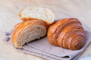 Fresh croissants bread on a kitchen paper. French breakfast.