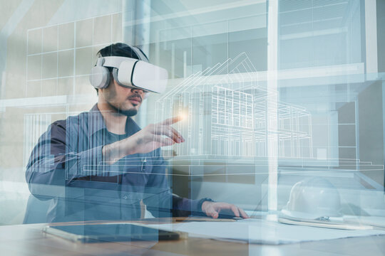 Asian Man Architect Or Engineer Wearing VR Headset For Working Design 3D Architectural Building Model With BIM Technology And Virtual Reality Technology. Concept Futuristic Design.