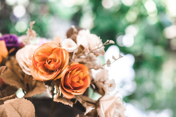 Obraz na płótnie Canvas artificial rose in bouquet on bokeh background, selective focus