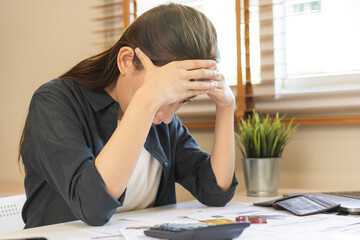 Financial owe asian woman sitting cover face with hands, stressed by calculate expense from invoice or bill, have no money to pay, mortgage or loan. Debt, bankruptcy or bankrupt concept.