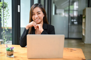 Portrait of a beautiful asian businesswoman sits at her office workplace.