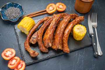 Honey BBQ Pork Ribs, Pork Spare Ribs with Barbecue spicy sauce, Grilled sliced barbecue pork ribs on black plate.