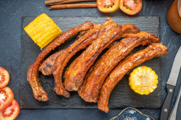 Honey BBQ Pork Ribs, Pork Spare Ribs with Barbecue spicy sauce, Grilled sliced barbecue pork ribs on black plate.