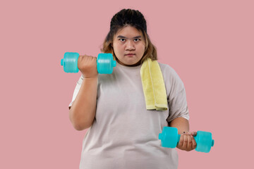 Asian large girl doing fitness exercises with dumbbells isolated.