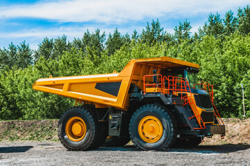 A large quarry dump truck in a coal mine. Mining equipment for the transportation of minerals.