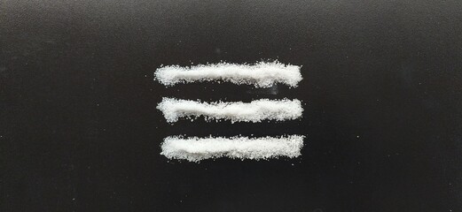 Three line, path or road of pure white cocaine or heroin powder isolated on black table background...