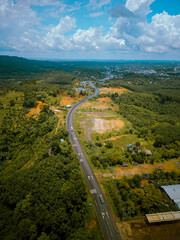 Aerial view of National Route 14 in Binh Phuoc province, Vietnam with hilly landscape and sparse population around the roads