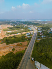 Aerial view of National Route 14 in Binh Phuoc province, Vietnam with hilly landscape and sparse population around the roads