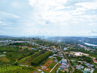 Aerial view of National Route 14 in Kien Duc town, Dac Nong province, Vietnam with hilly landscape and sparse population around the roads.