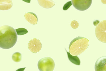 Flying lime fruits, for background in green color.