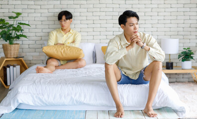 Two Asian young upset unhappy stressed depressed sad teenager male gay men lover couple partner...