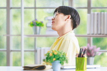 Asian young handsome teenager gay man model in casual outfit sitting posing gesture while unrecognizable painter using paintbrush drawing painting color picture on canvas on wooden easel in studio