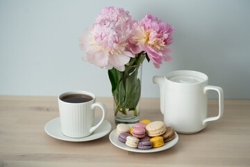 Tea time. Cup of tea with a teapot and macaroon.	
