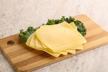 Sliced Gouda cheese over board