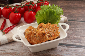 Fried salmonn cutlet in the bowl