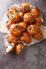 Krentenbollen Dutch Fresh baked Currant Rolls closeup on a table. Vertical top view from above