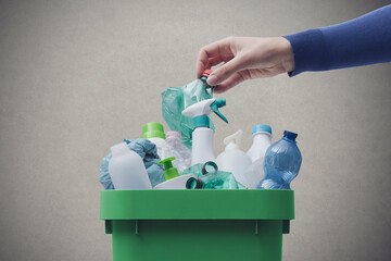 Woman putting plastic in the recycling bin