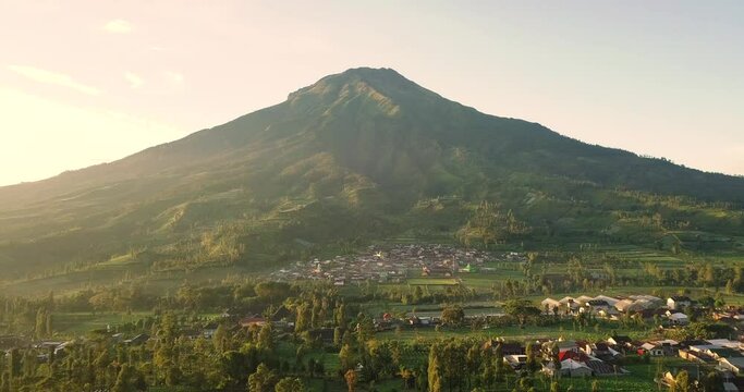 wide aerial view of mount sumbing and the surrounding plantations at wonosobo indonesia at sunrise