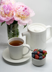 Сup of tea, peony and berries.