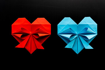 colored hearts made of paper on a black background. love concept