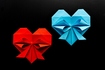 colored hearts made of paper on a black background. love concept