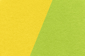 Texture of craft green and yellow paper background, half two colors, macro. Structure of vintage olive craft cardboard.