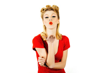 Portrait of a pretty blonde woman over white background, air kiss.