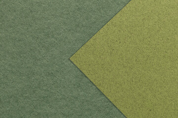 Texture of dark green and olive paper background, half two colors with arrow, macro. Structure of khaki craft cardboard - obrazy, fototapety, plakaty