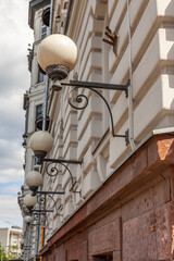 Fototapeta na wymiar Moscow, Russia, June 4, 2022. Beautiful street lamps at facade of historical building