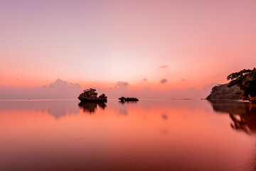 Naklejka na ściany i meble Peaceful seascape at dusk in pink shades.