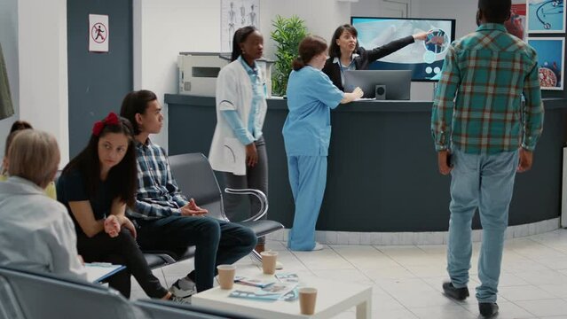Busy hospital reception lobby with diverse patients to attend checkup visit, using appointment report to help people with disease. Waiting room area for healthcare consultation and examination.