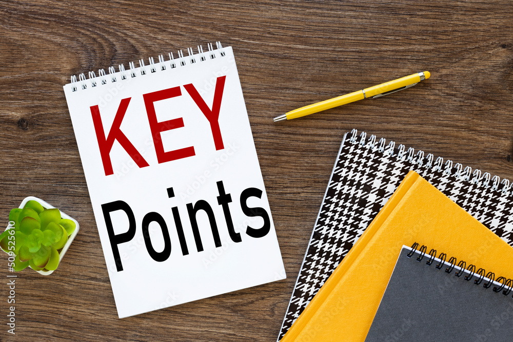 Poster key points wooden dark background text on notepad with spiral near different notepads of yellow pen 