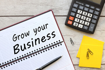 grow your business. business cycle text on planner page on the table